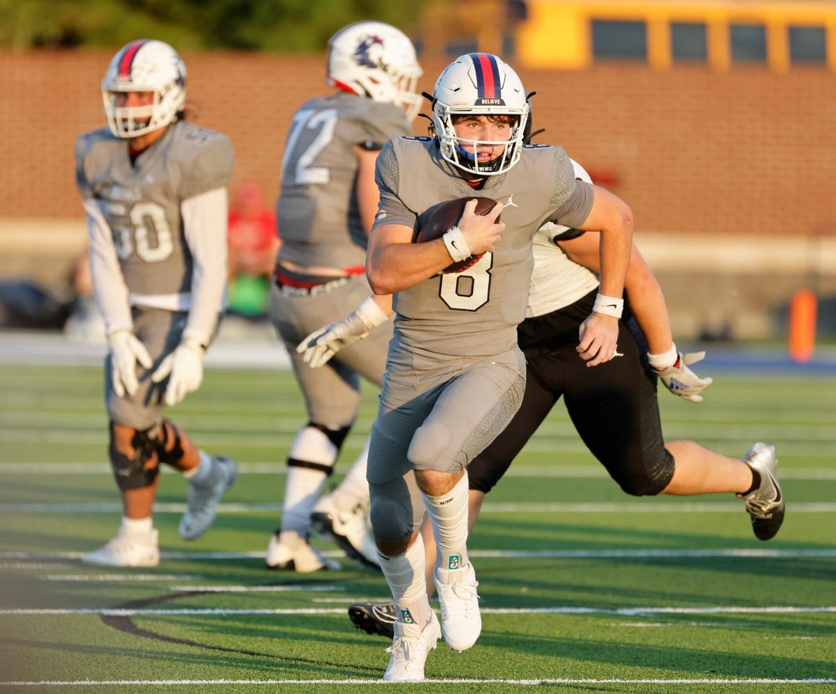 Richland quarterback Drew Kates (8) scrambles up the middle on a broken play during a UIL football game at Birdville Fine Arts and Activity Center in North Richland Hills Friday, Sept. 6, 2004.