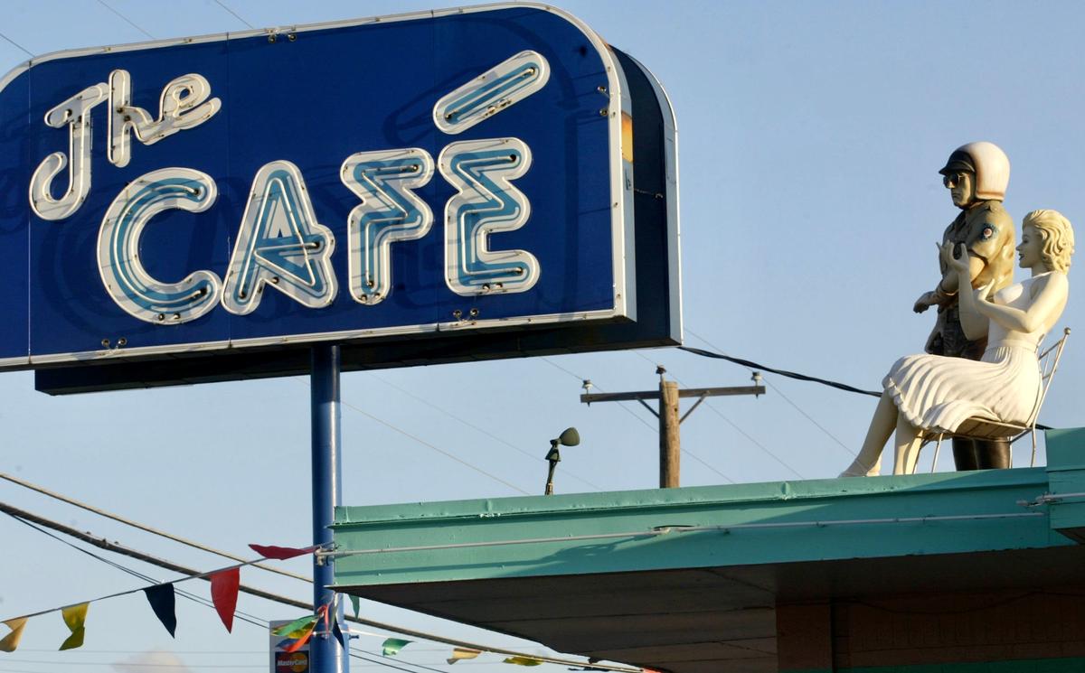 Statues of Marilyn Monroe and a police officer rest atop The Cafe in Haltom City, changing to a Dickey’s Barbecue Pit.