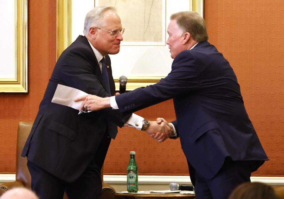 Guest speaker Ross Perot Jr. presents interviewer Mike Berry an envelope with a donation at the Exchange Club Christmas luncheon for Children's Charities on Wednesday Dec. 03, 2025 at The Fort Worth Club in Fort Worth, Texas.