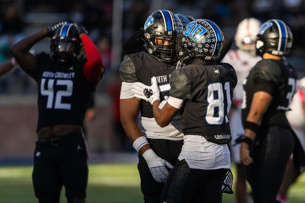 North Crowley defensive lineman DeMorey Beasley (31) is consoled by his teammate Malachi Johnson (81) after dropping a pass on a fake punt in the first half of the Class 6A Division I state semifinal game at Eagle Stadium in Allen on Saturday, Dec. 14, 2024.