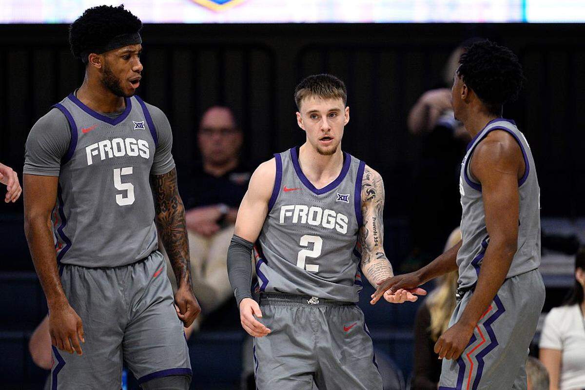 SAN DIEGO, CALIFORNIA - NOVEMBER 28: Brock Harding #2 is congratulated by Jayden Pierre #1 of the TCU Horned Frogs during the first half against the Wisconsin Badgers in the Rady Children's Invitational Championship game at Jenny Craig Pavilion on November 28, 2025 in San Diego, California. (Photo by Orlando Ramirez/Getty Images)
