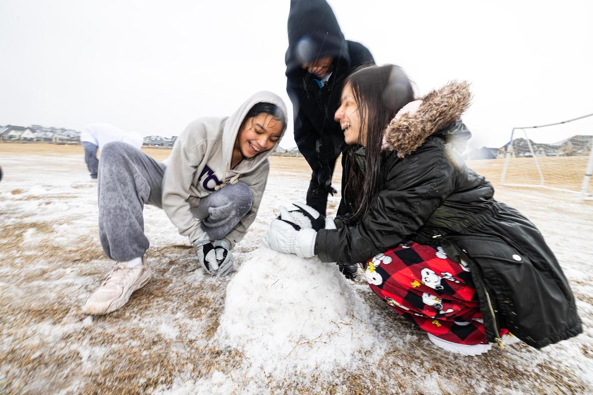 Stripling Middle School students Cecilia Rico, 14, Mia Rodriguez, 14, and Ariana White, 14, build a snowman in their neighborhood park in Southwest Fort Worth on Thursday, Jan. 9, 2025. The winter storm led to all Fort Worth ISD schools to close for the rest of the week.
