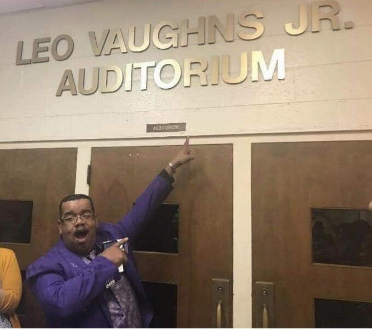 Kirkpatrick Middle School teacher Leo Vaughns Jr. poses in front of the school auditorium named in his honor after the Fort Worth ISD school board voted in 2019 to name it after him. He started at the school as a music teacher before pivoting to English Language Arts. The 2025-26 school year will mark 36 years of him teaching at the campus.