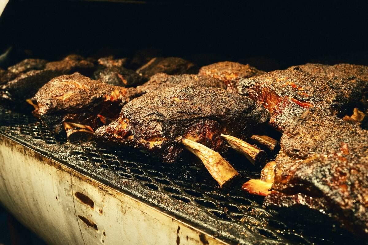 Beef ribs on the pit at Terry Black’s Barbecue.