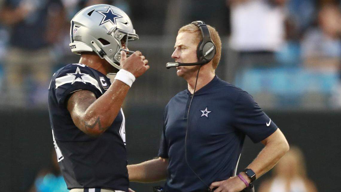 Cowboys’ quarterback Dak Prescott, left, talks with head coach Jason Garrett, during the second half of the Cowboys’ 16-8 loss to the Carolina Panthers on Sunday at Bank of America Stadium in Charlotte, N.C.