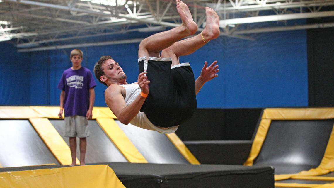 In this 2013, photo, Jacob Terrell flips at an indoor trampoline park in Orem, Utah. The state is one of 11 that now regulate these centers.