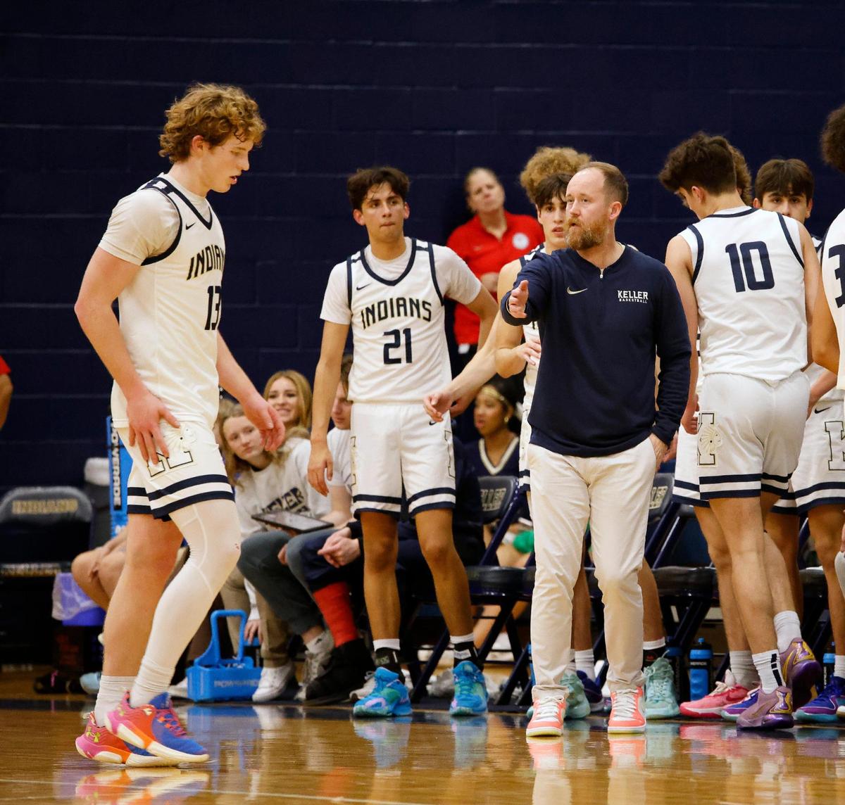 Keller head coach Zachary Weir gives point guard Brooks Bahr (13) a little direction during a time out in the second period of a high school basketball game in the Keller High School gym in Keller Texas, Friday, Feb. 02, 2024.