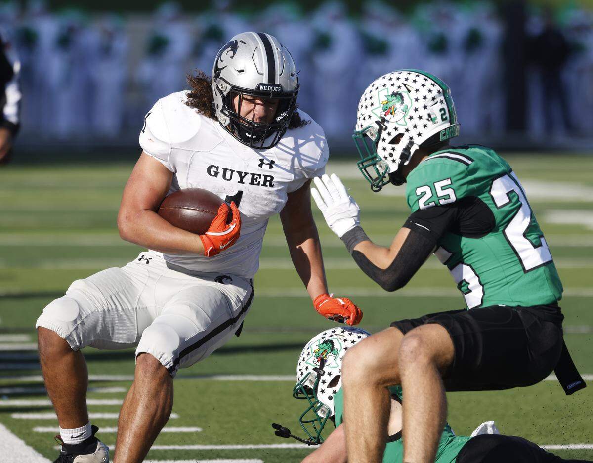 Southlake Carroll defensive back Gavin Strange (25) forces Denton Guyer running back Kaedyn Cobbs (1) out of bounds during the first half of a UIL Class 6A Division II Quarterfinal on Saturday Dec. 06, 2025 at Crowley ISD Multi-Purpose Stadium in Fort Worth, Texas.