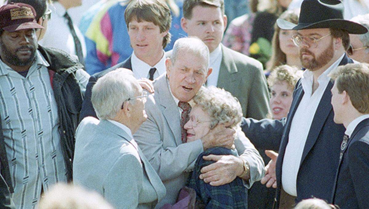 February 22, 1993: Wrestler Kerry Von Erich’s funeral held at First Baptist Church in Dallas. His father, Jack Adkisson, is consoled as he leaves the graveside ceremony at Grove Hill Cemetery in Dallas. Kevin Von Erich is seen behind him.