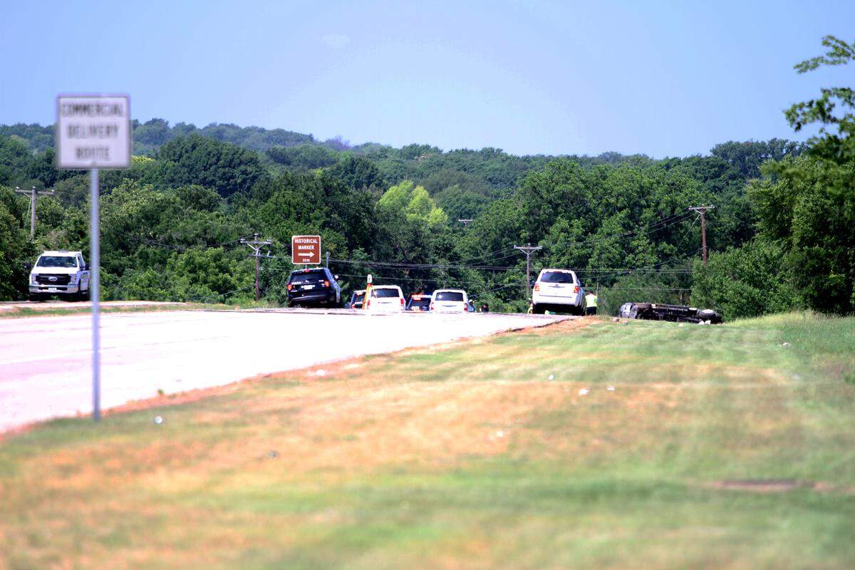 An overturned vehicle is seen on the right shoulder of Camp Bowie Boulevard West on Tuesday. Police have taken custody of the driver who hit a road crew worker.