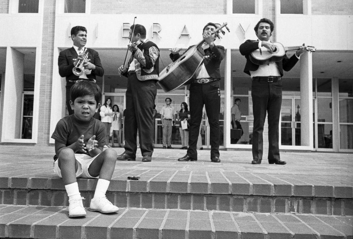 Sept. 11, 1972: Adam Geisel, 4, listens to music of Las Estrellas de Valisco band at the opening of the University of Texas at Arlington Library’s new cultural minorities center. Musicians, left to right, are Chapo Parra, Manuel Garcia, Joe Moron and Juan Moreno.
