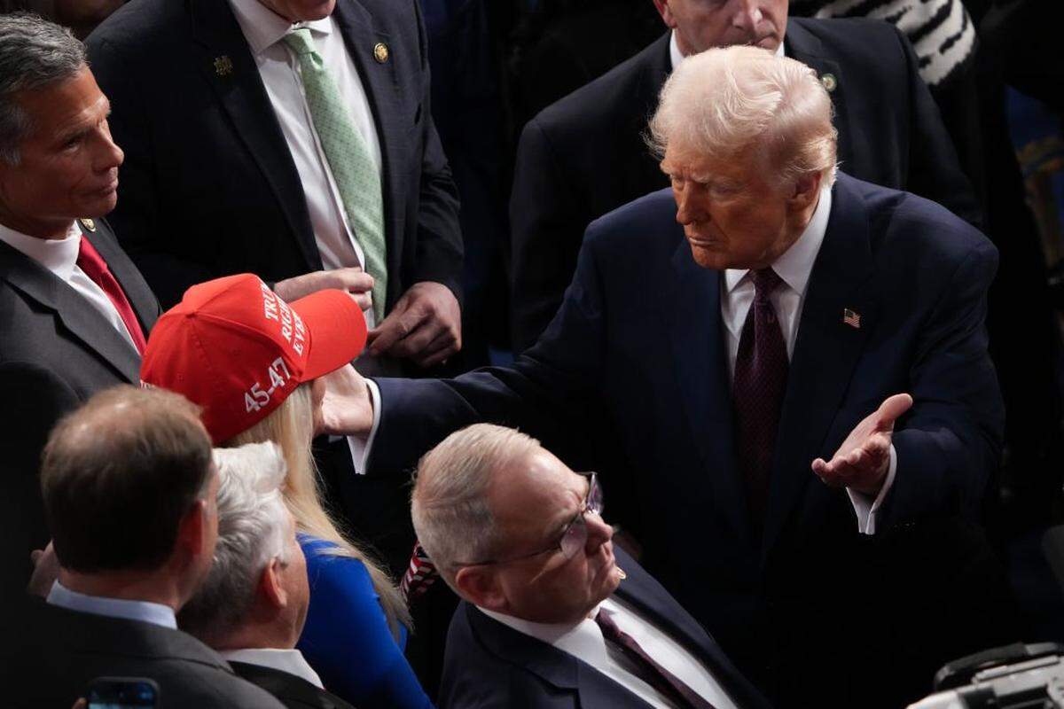 President Donald Trump hugs Rep. Marjorie Taylor Greene, R-Georgia, after addressing a joint session of Congress March 4 at the U.S. Capitol.