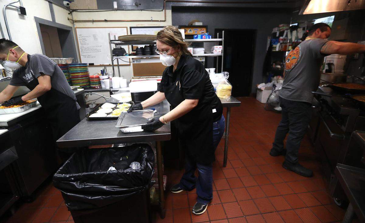 Mary Patino Perez, owner of Enchilada Ol in Fort Worth, cooks family-sized meals for curbside pickup on Thursday, April 2, 2020. The restaurant has reopened after closing for 14 days to assess the situation during the coronavirus pandemic.