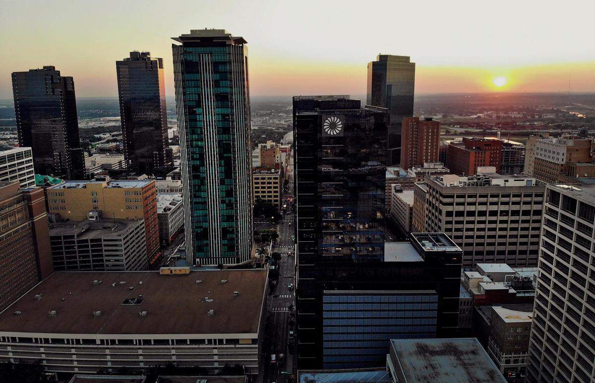 The sun rises behind downtown Fort Worth’s skyline on Friday, September 9, 2022.