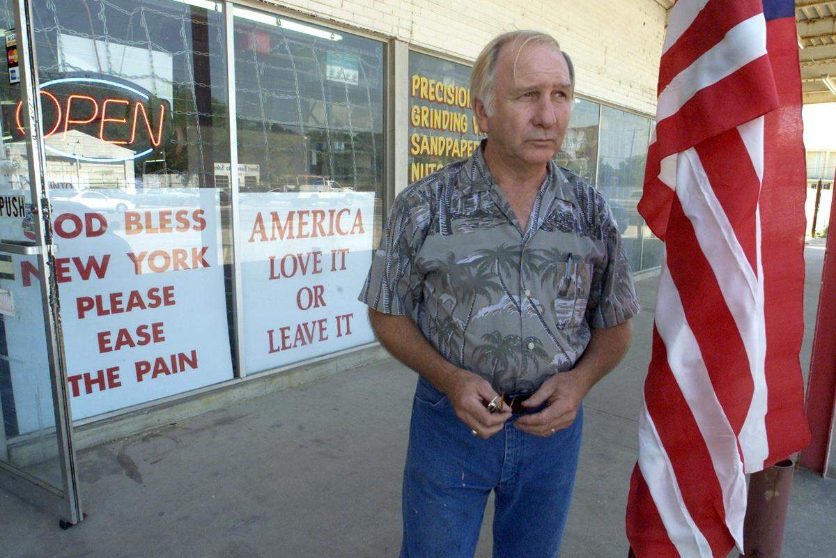 Bill Williams, the owner of Tool Company in Fort Worth, stands in the front of his store where he has placed signs to show how he feels about terrorist events in Washington D.C and New York.