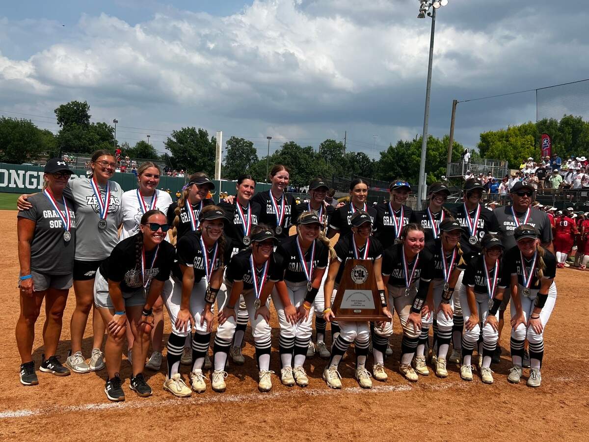 Grandview softball poses with the Class 3A state championship runner up trophy at Red & Charline McCombs Field on May 30, 2024.