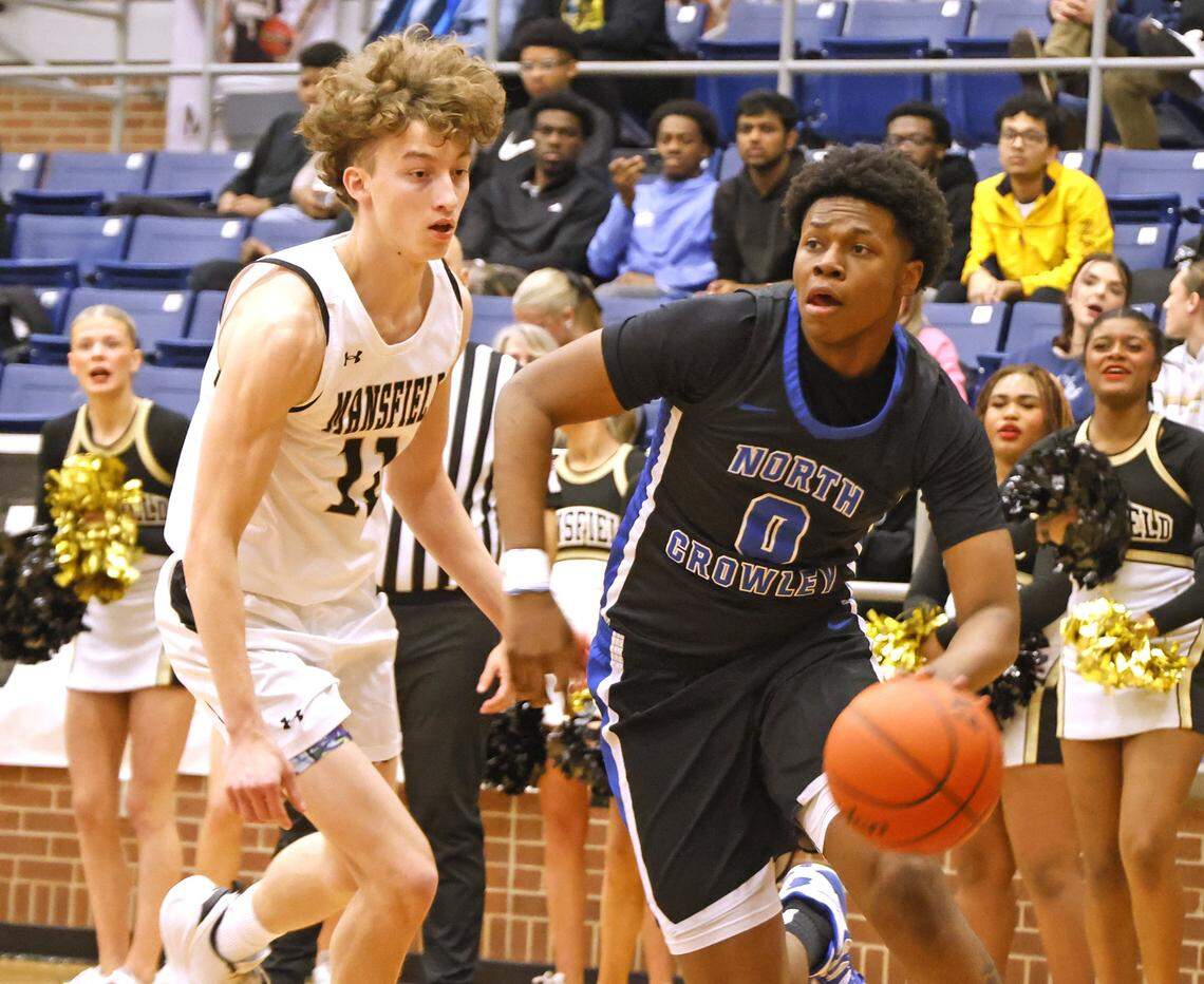 North Crowley wing Bennjamin Jones (0) drives against Mansfield's Jack Larsen (11) during the first half of a UIL boys basketball game between North Crowley and Mansfield at Mansfield High School in Mansfield, Texas, Tuesday Jan. 20, 2026