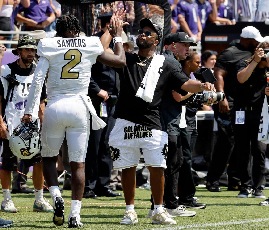 Colorado quarterback Shedeur Sanders (2) is congratulated returning to the sideline after throwing a touchdown catch the second half of a NCAA football game at Amon G. Carter Stadium in Fort Worth,Texas, Saturday Sept. 02, 2023. Colorado defeated TCU 45-42. (Special to the Star-Telegram Bob Booth)