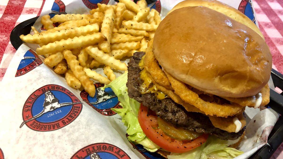 The new Wrangler Burger at Trailboss Burgers features onion strings and spicy ranch dressing.
