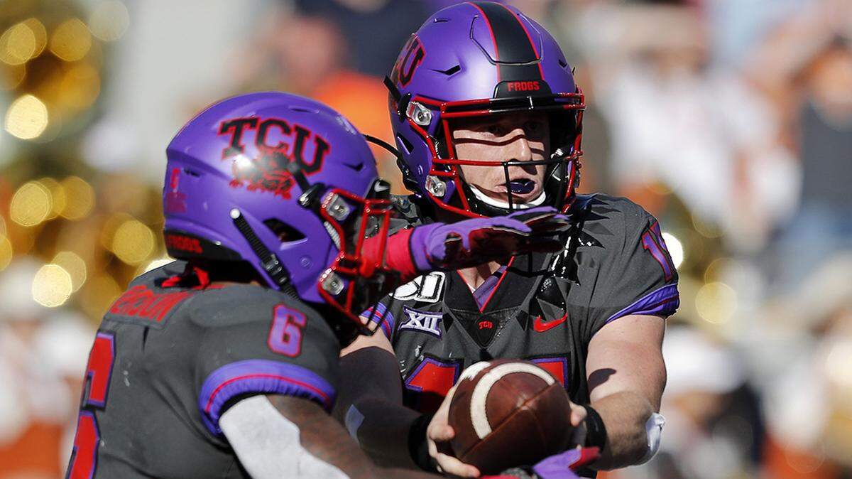 TCU running back Darius Anderson (6) takes the ball from quarterback Max Duggan (15) during the first half of a NCAA football game at Amon G. Carter Stadium in Fort Worth, Texas, Saturday, Oct. 26, 2019. Texas led 17-13 at the half. (Special to the Star-Telegram Bob Booth)