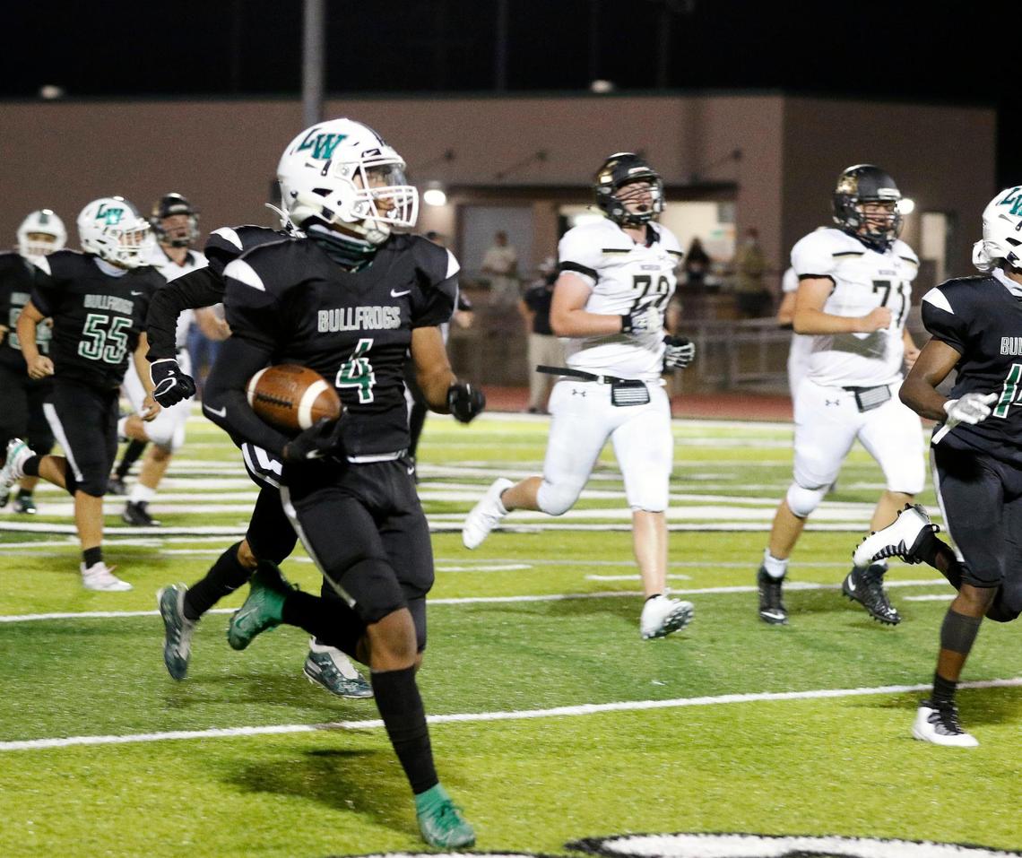 Lake Worth safety Isiah Hall (4) leads both teams down the field for a long return during a high school football game at Kittrell Memorial Stadium in Lake Worth, Friday Aug. 28, 2020. Lake Worth defeated McGregor 47-43 to start the season. Temperatures were 111 at the start the game and 94 when it ended. (Special to the Star-Telegram Bob Booth)