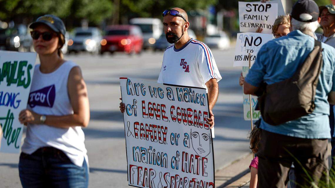 Ernie Moran, center, stands with fellow activists protesting the policy of separating immigrant children from their parents detained at the southern border on Friday on University Drive in Fort Worth. Local activists have been protesting at that location near Republican U.S. Rep. Kay Granger's office every week for over a year.