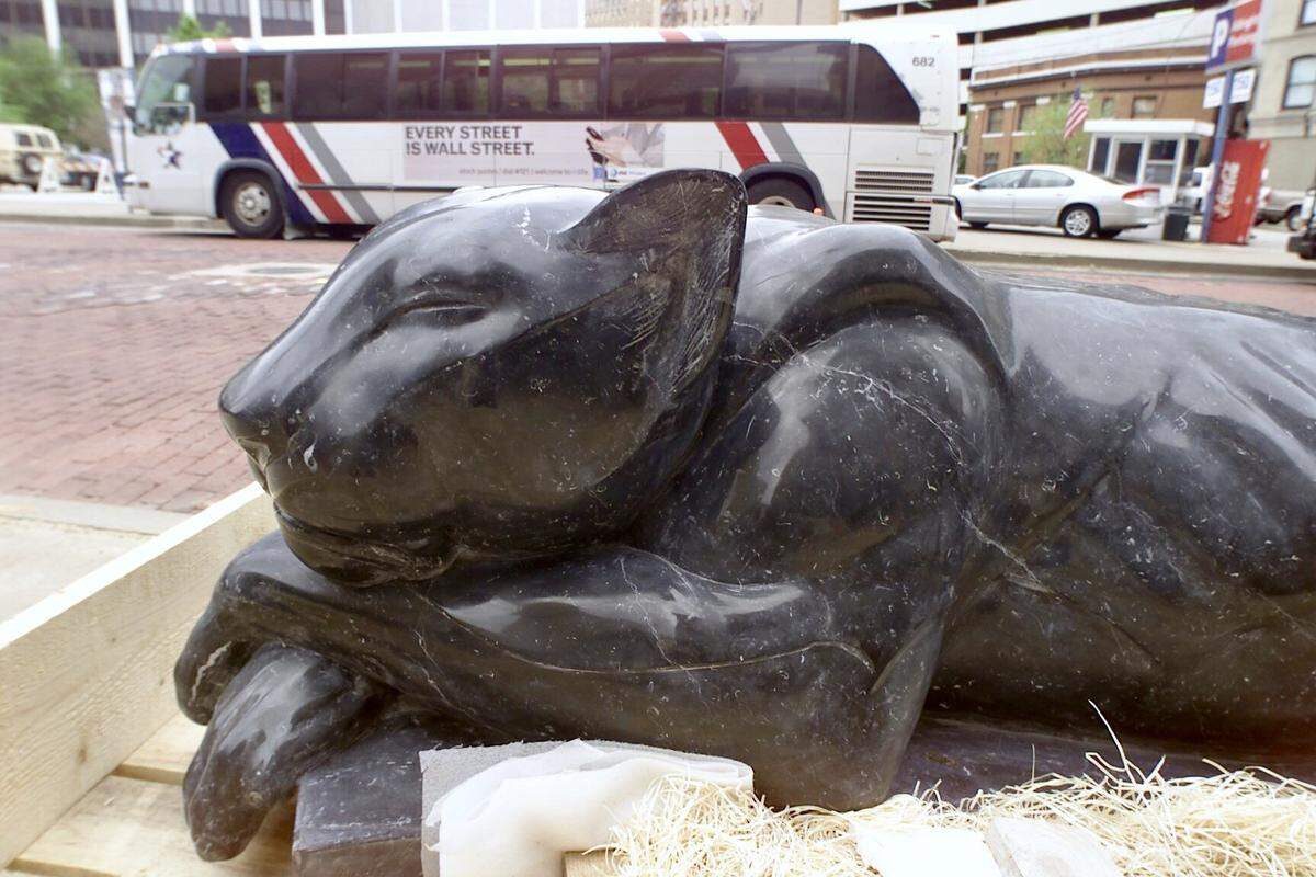 Two sleeping panther sculptures lie downtown, one on Main Street and one on West Ninth Street.