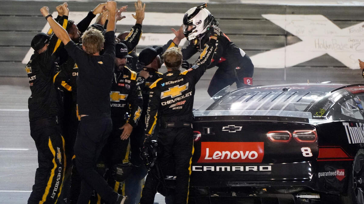 Tyler Reddick celebrates with his crew on the track after winning the the NASCAR Cup Series auto race at Texas Motor Speedway in Fort Worth, Texas, Sunday, Sept. 25, 2022. (AP Photo/Larry Papke)