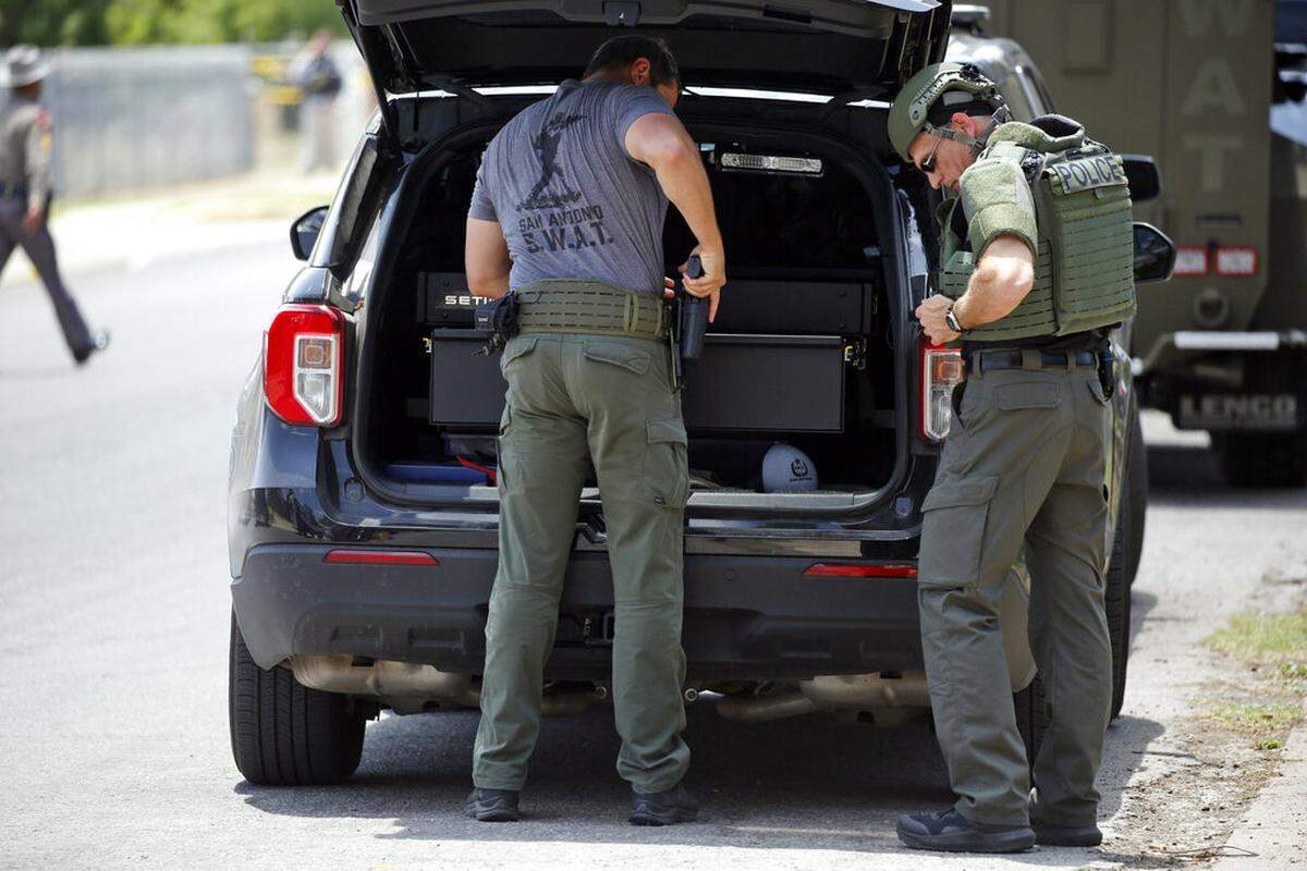 Law enforcement personnel gather gear outside Robb Elementary School following a shooting, Tuesday, May 24, 2022, in Uvalde, Texas. (AP Photo/Dario Lopez-Mills)