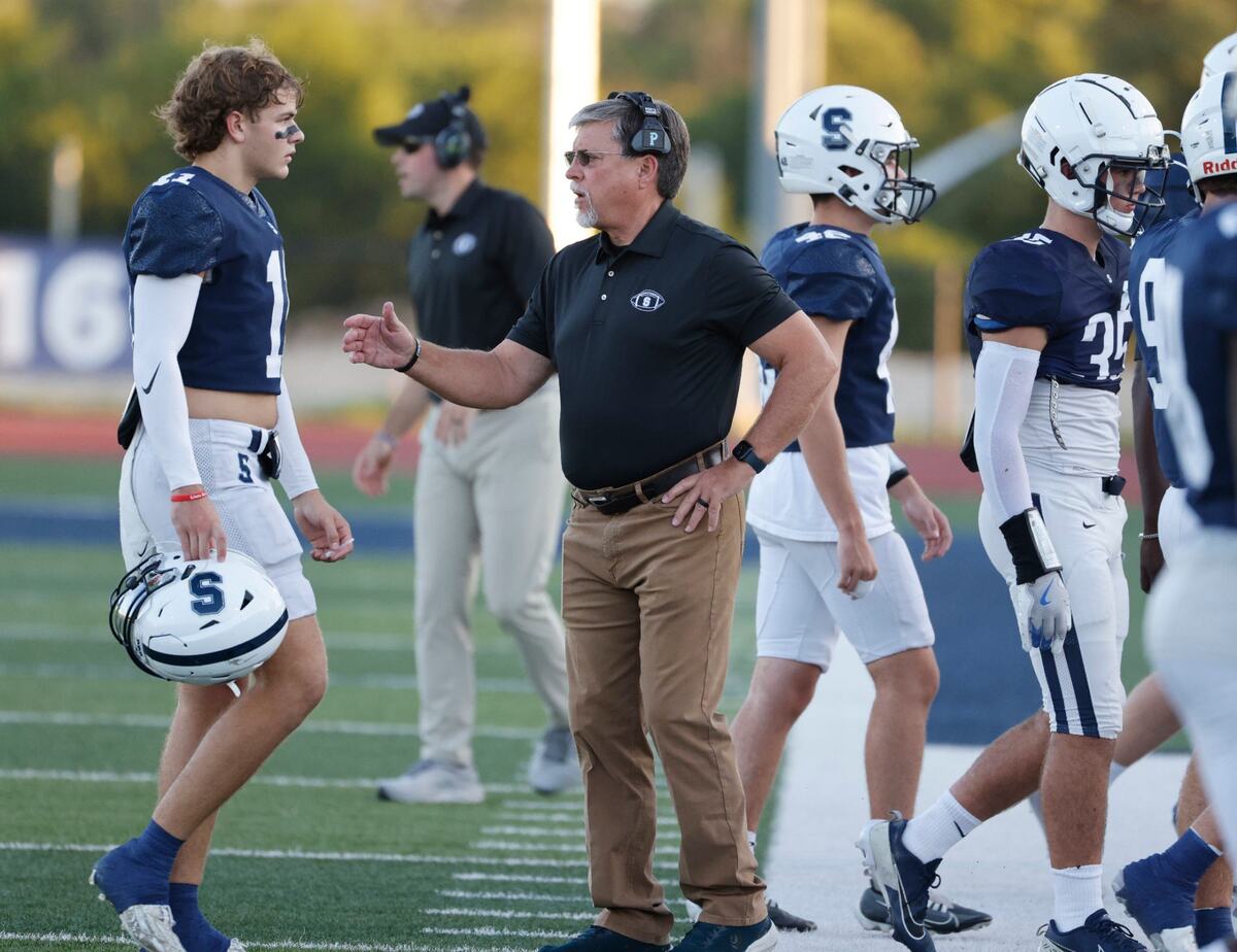 All Saints head coach Aaron Beck greets players as the come off the field before a TAPPS football game at All Saints High School’s McNair Stadium in Fort Worth Thursday, Sept. 12, 2024.