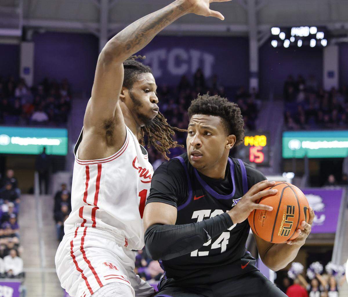 TCU forward Xavier Edmonds (24) works in front of Houston forward Joseph Tugler (11) during the first half of a NCAA basketball game between the University of Houston and TCU at Schollmaier Arena in Fort Worth, Texas, Wednesday Jan. 26, 2026