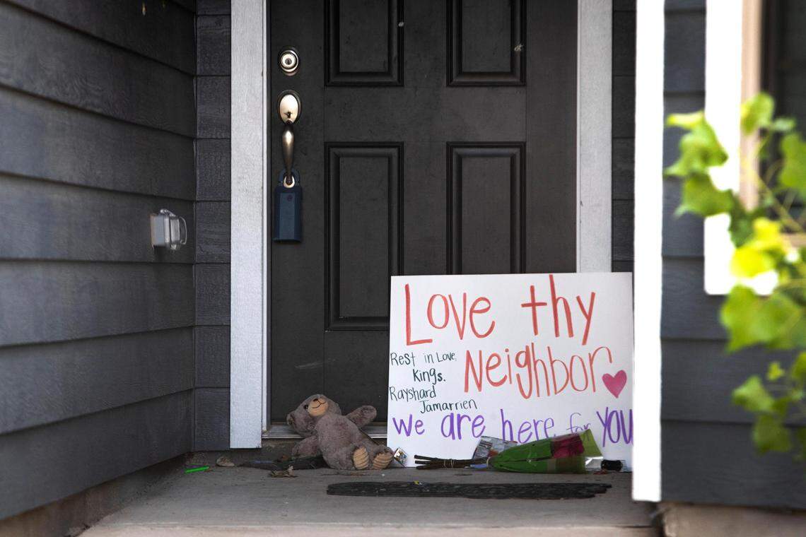 Flowers and other items sit at the door of a home in the Quarter Horse Estates neighborhood of Fort Worth, where 5-year-old Rayshard Scott and 17-year-old Jamarrien Monroe were fatally shot in August 2022. A toddler was also hurt in the shooting.