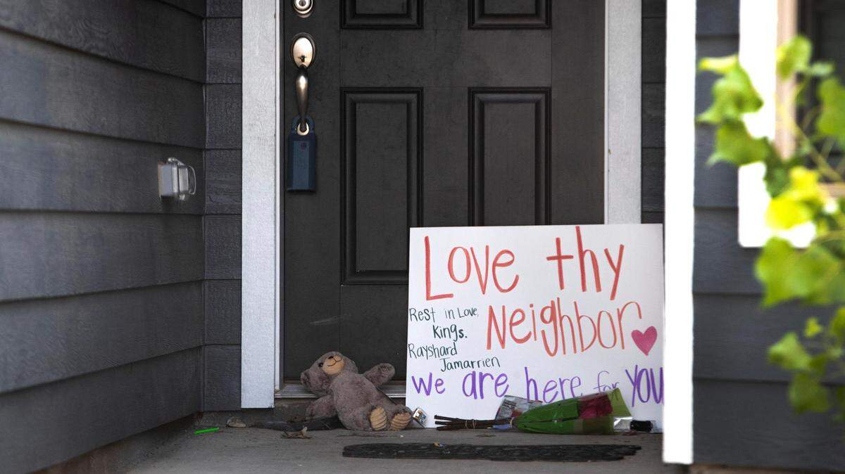 Flowers and other items sit at the door of a home in the Quarter Horse Estates neighborhood of Fort Worth in August after a 5-year-old and a 17-year-old were fatally shot. A toddler was also hurt in the shooting.