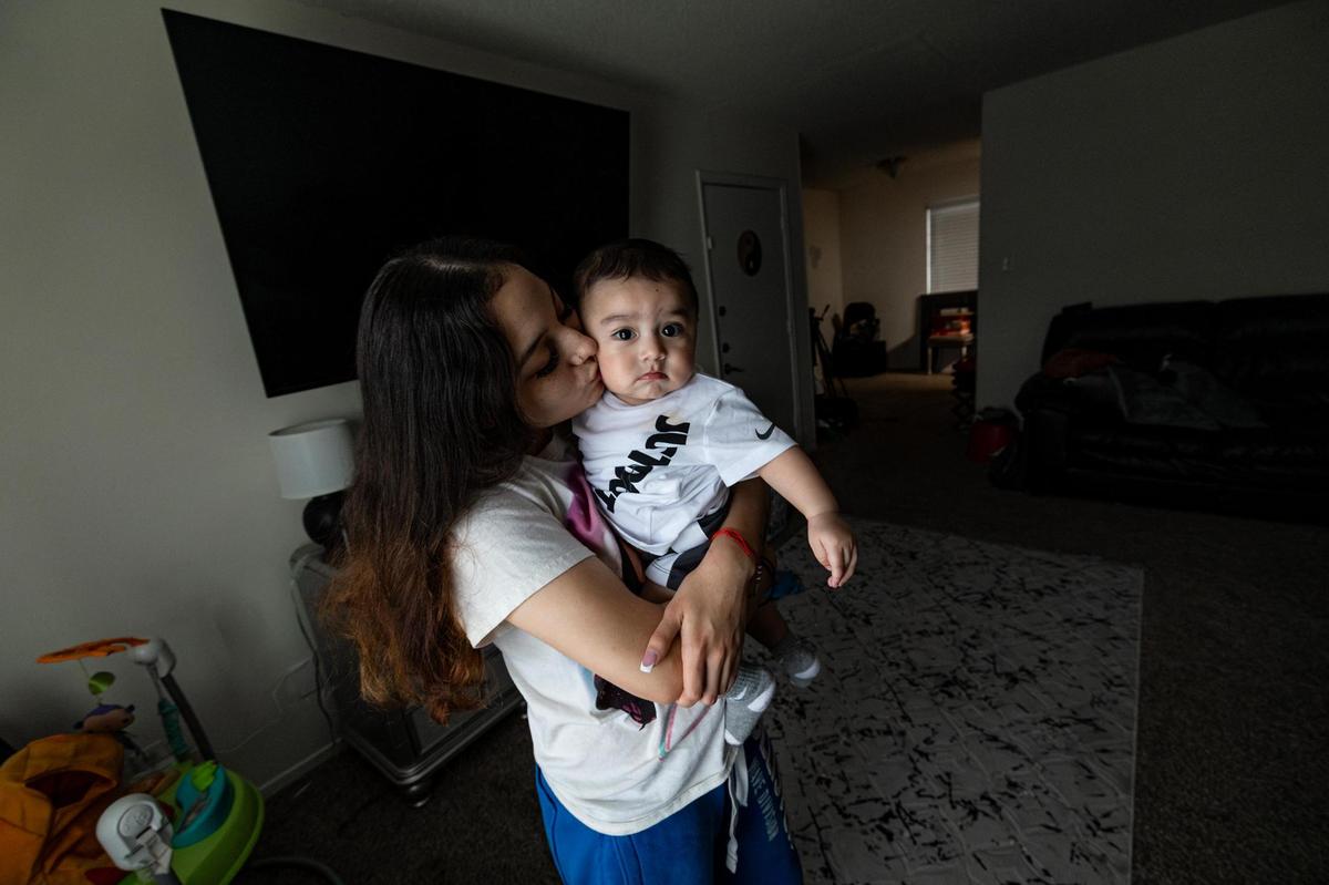 Corina Camacho kisses her son Zechariah Emilio at her apartment in Fort Worth on April 9. The father of her child, Zechariah Trevino, was shot and killed outside of a Whataburger near Paschal High School in January 2023.