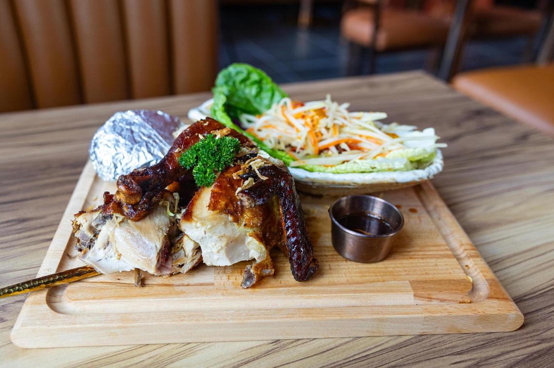 The E San Classic consisting of thai-style papaya salad, sticky rice and roasted marinated chicken at the new Ko Thai restaurant on Magnolia Avenue in Fort Worth on Tuesday, April 29, 2025.