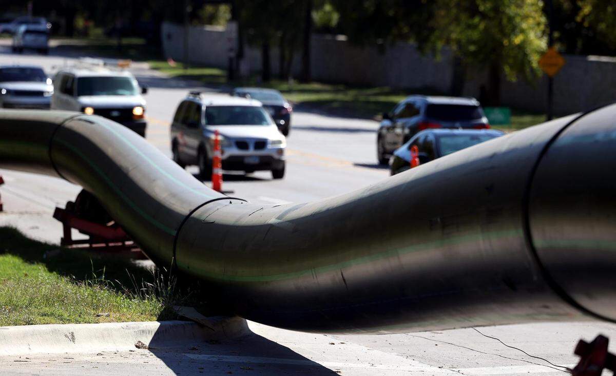 A large pipe runs along the northbound side of University Drive on Tuesday, October 17, 2023, in Fort Worth. The two right lanes were closed for construction from around Trinity Park Drive to Trail Drive.