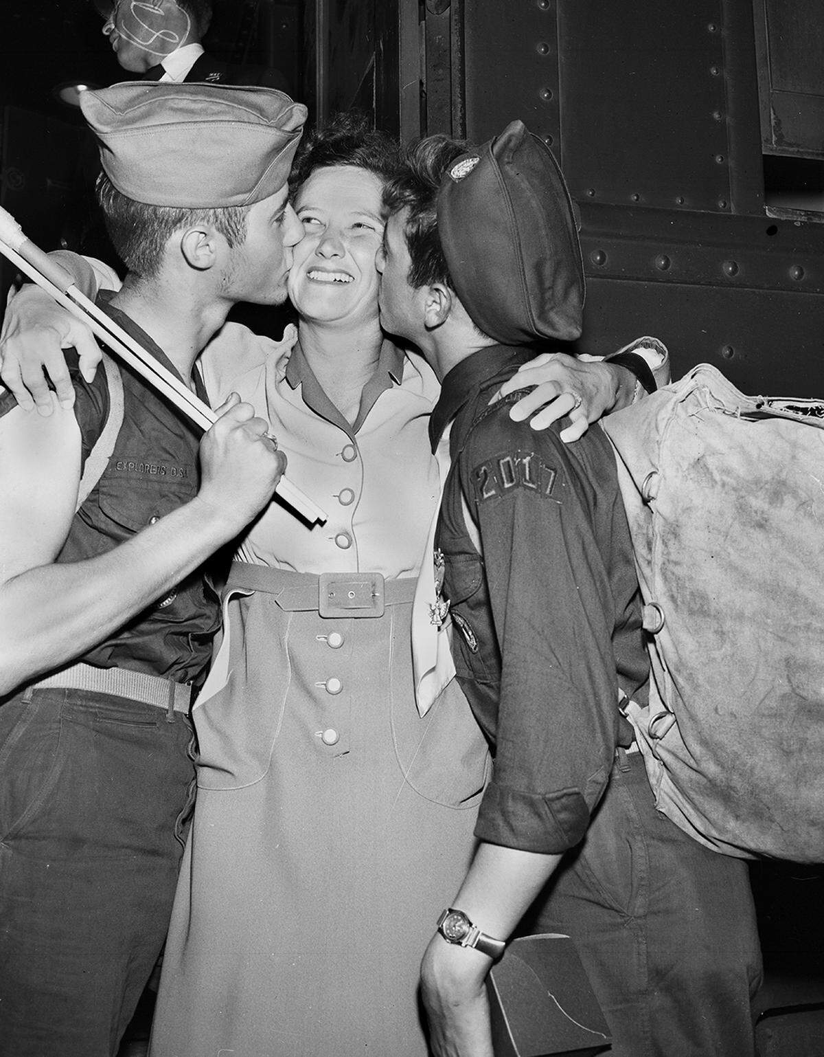 July 10, 1950: Carl Jr., left, and Ronald Graner greet their mother, Mrs. Carl Graner, with a kiss at T&P Station. They both attended the Boy Scout Jamboree at Valley Forge, Penn., with 105 other Fort Worth Scouts. They are Eagle Scouts of Explorers Post 2017.