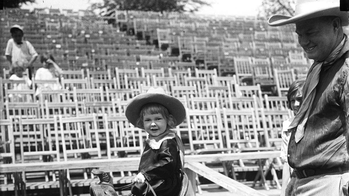Fog Horn Clancy admires his son John P. Clancy – one of two sons known as Foghorn Jr., at the 1923 “Passing of the West” show.