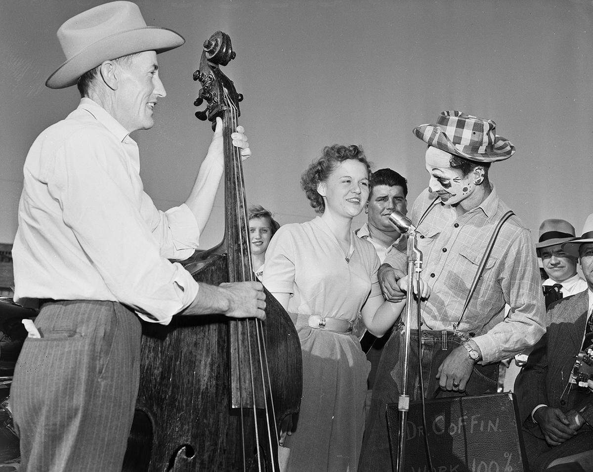 1951: Clown Joe Henry Thomason, right, checks the pulse of singer Patsy Admire as she entertained at Handley. The two were part of a motorcade touring eight towns to boost the third annual Keller Fair.