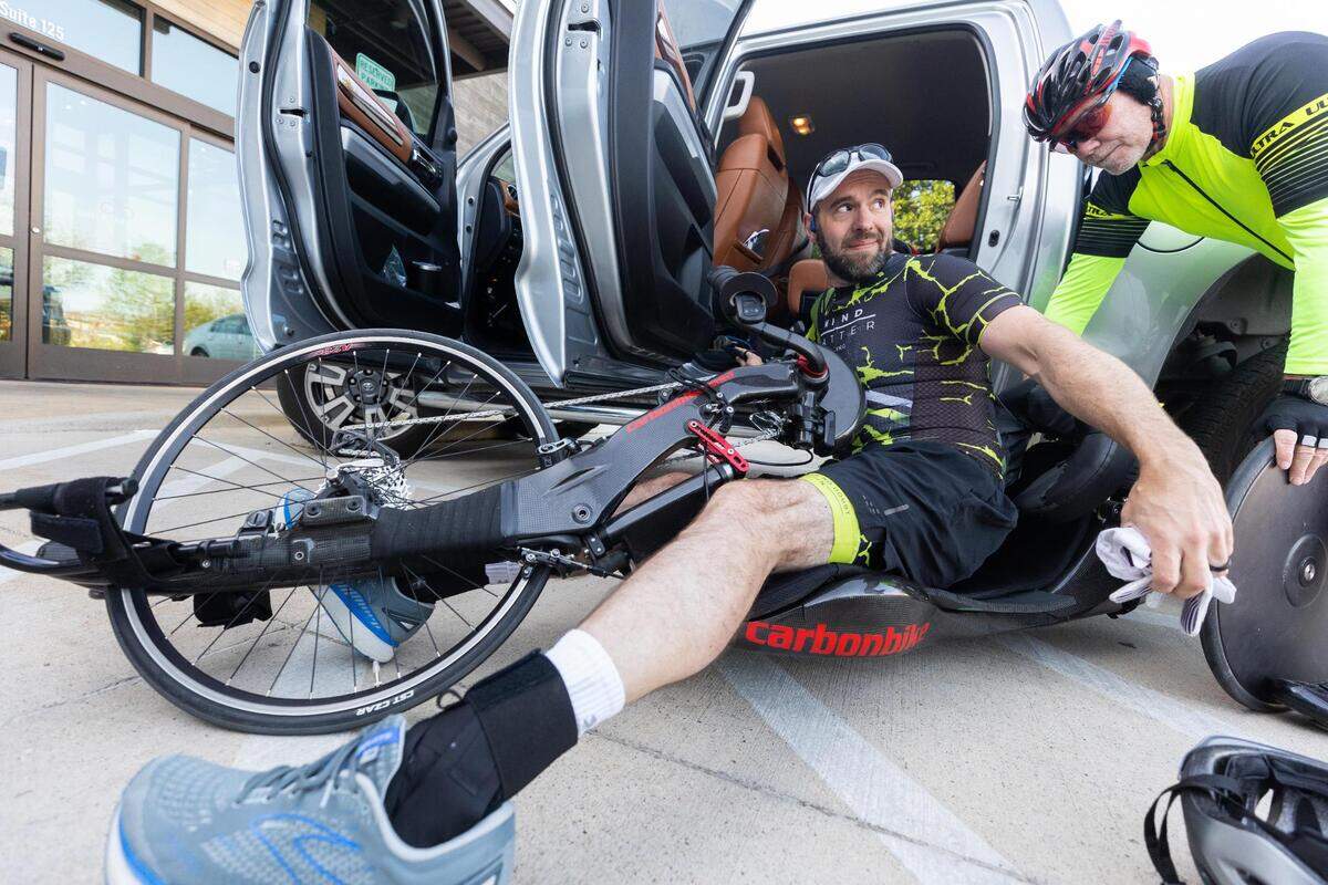 Trent Fielder gets into his bike before he heads out for a 100-mile ride on the Trinity Trails on April 26, 2022, in Fort Worth. Fielder has Guillain-Barre syndrome and uses a specialized bike.
