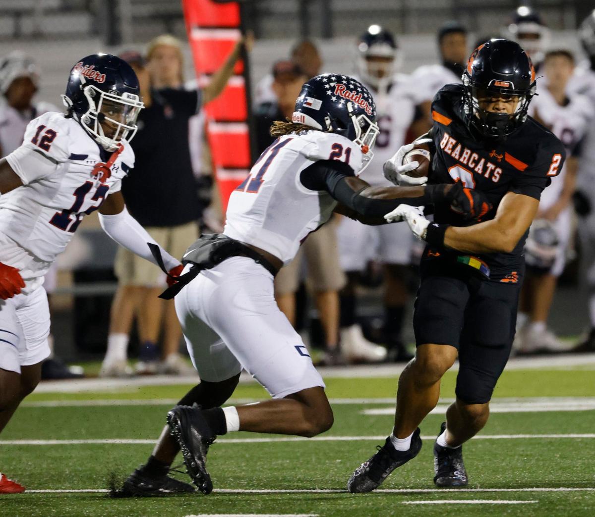 Aledo wide receiver Kaydan Finley (2) attempts to avoid the tackle of Denton Ryan linebacker Dillon Arkansas (21) during a UIL football game at Buchanan Stadium in Aledo Texas, Friday, Oct. 04, 2024.