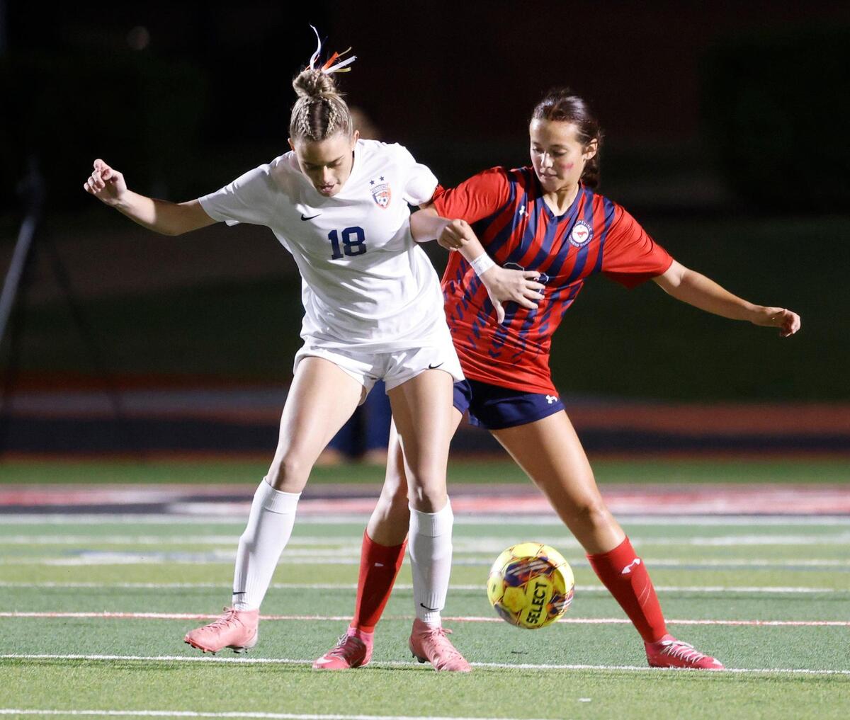 Frisco Wakeland forward Sydney Cooley (18) and Grapevine defender Calleigh Cryer (23) battle near mid field during the Class 5A D2 UIL state semifinal girls soccer playoff game at Buddy Echols Field in Coppell, Texas, Friday, Apr. 05, 2025.