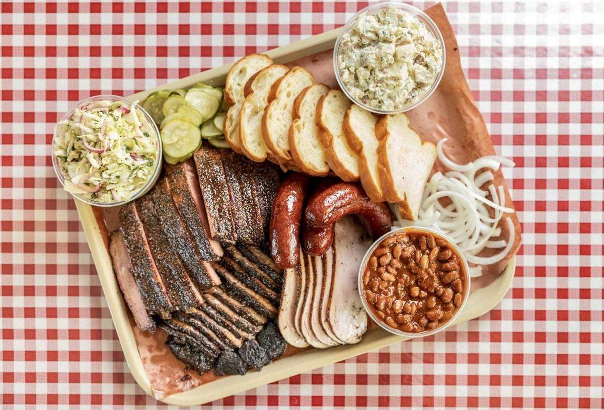 A combination plate at Goldee’s Barbecue with turkey, sausage, brisket, ribs, beans and slaw plus homemade bread.