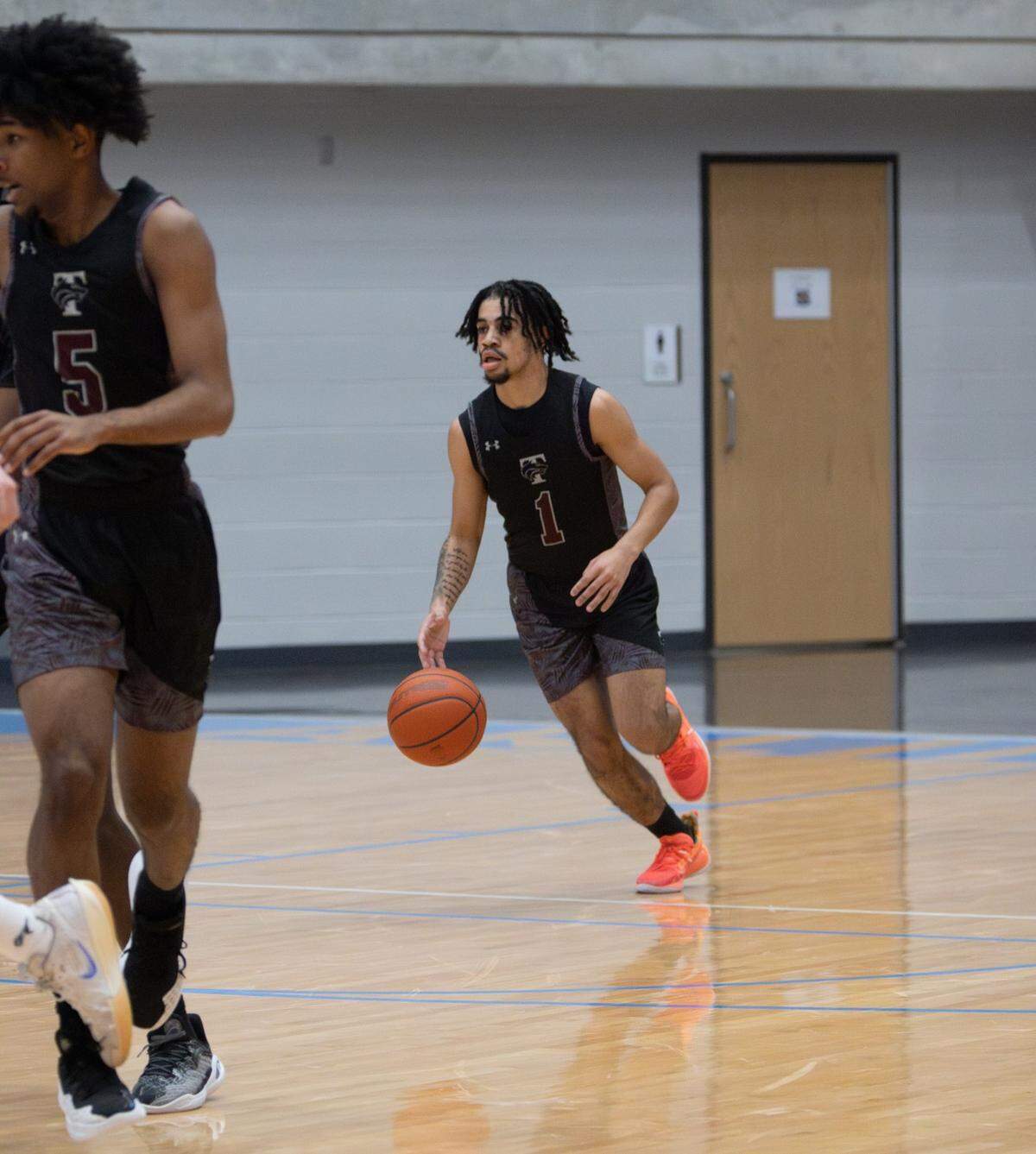 Mansfield Timberview’s Damien Jackson (1) brings the ball up the court against Fort Worth Paschal in a Class 5A Division 1 bi-district game on Tuesday, February 18, 2025 at the Arlington ISD Athletics Center in Arlington, Texas. Timberview defeated Paschal 62-39.