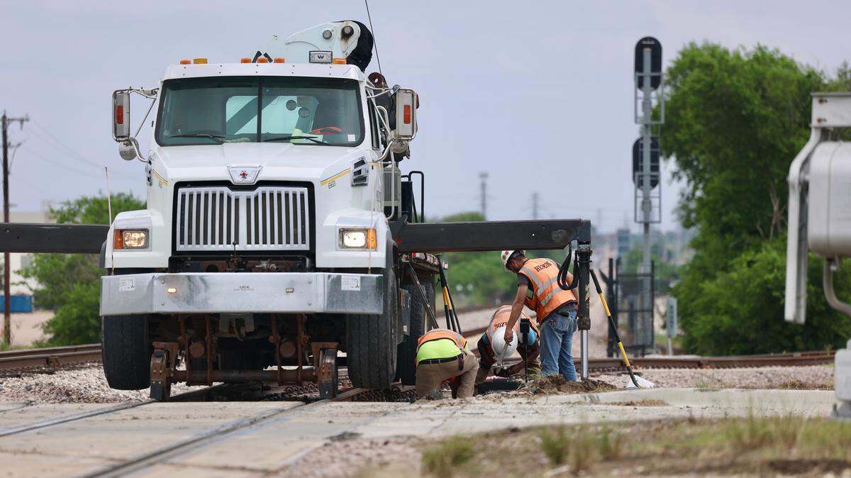 Crews work at the scene where a TEXrail train was involved in a crash with a vehicle on Sylvania Avenue in north Fort Worth on Wednesday, May 20, 2026. 