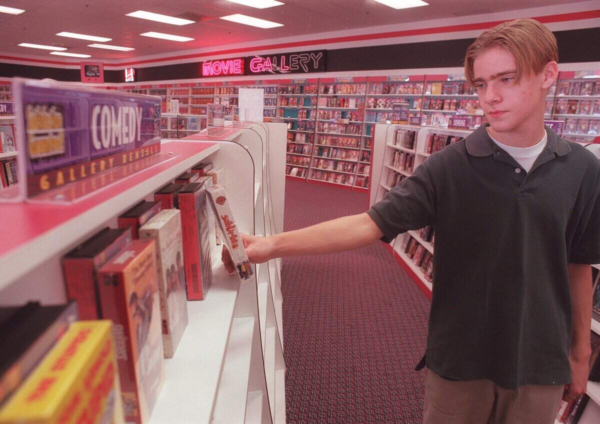 Ian Ticheleaut, 15, selects a video to rent from Movie Gallery in Bedford to watch on New Year's Eve. Photo taken on December 31, 1999.