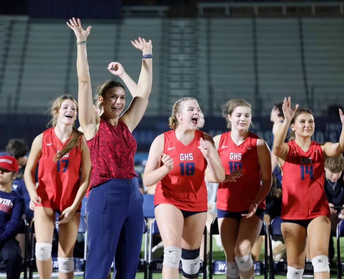 Grapevine head coach Robyn Wallace celebrates a point with her team during the Showdown at Sundown outdoor exhibition volleyball game at Liberty Christian High School in Argyle, Texas, Tuesday, Oct. 29, 2024.