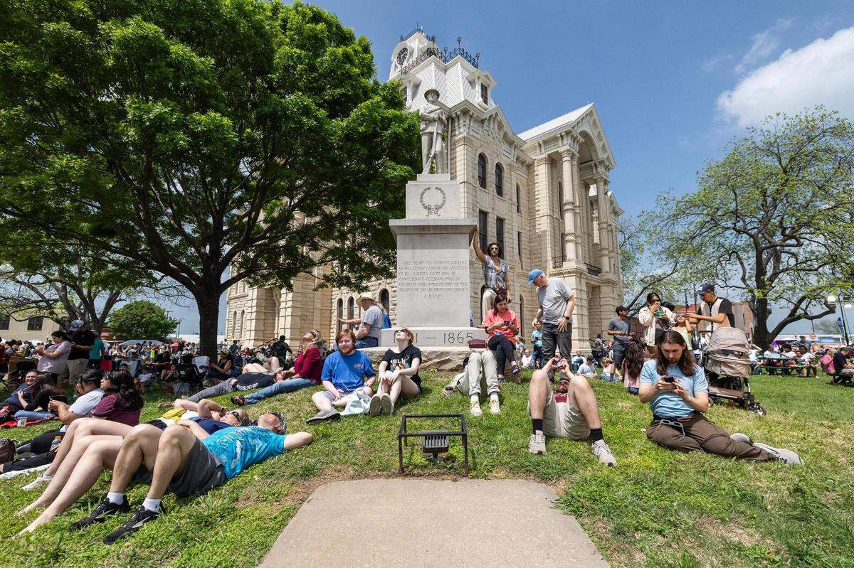Hundreds of people sit down to view the Great North American Eclipse at the Hillsboro courthouse in Hillsboro on Monday, April 8, 2024.