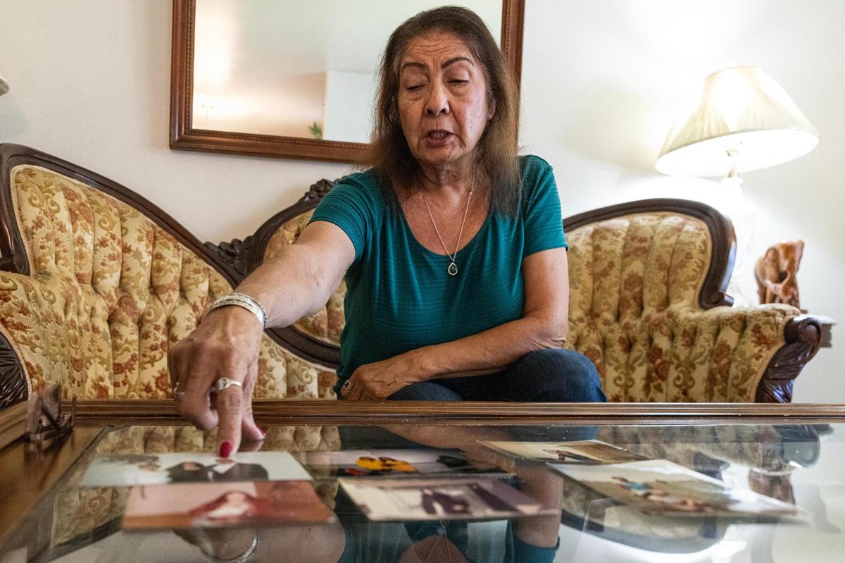Dallas resident Alice Salas shows old photos of herself from her past. In 2008, Salas was diagnosed with ovarian cancer and had to undergo a full hysterectomy and chemotherapy. Now, Salas has to live with the effects of the chemotherapy that has left her scalp exposed and eyebrows bare.