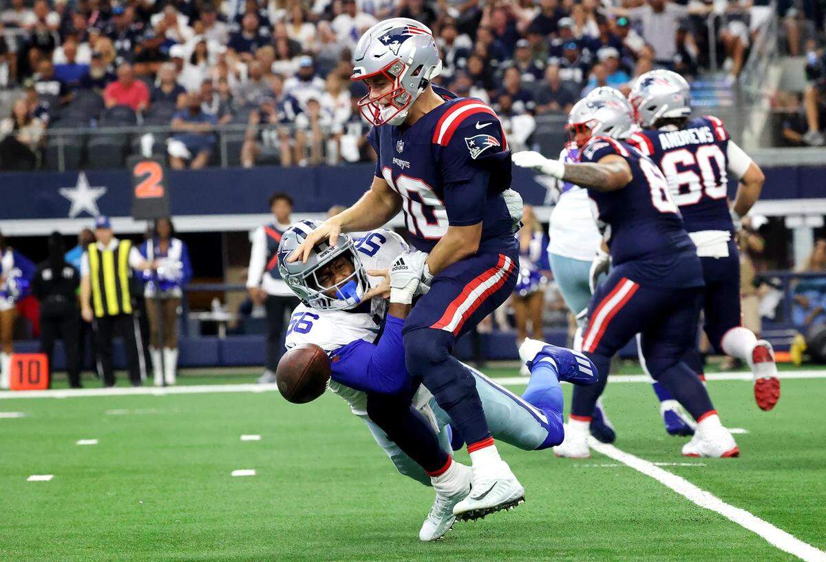 Dallas Cowboys defensive end Dante Fowler strips the ball from New England Patriots quarterback Mac Jones on Sunday, October 1, 2023, at AT&T Stadium in Arlington.